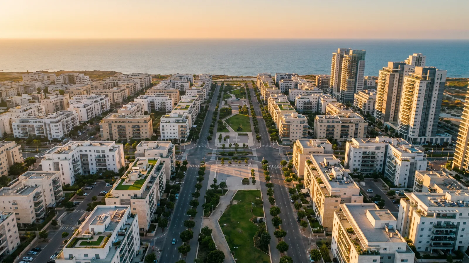 Aerial view of a planned coastal district at golden hour